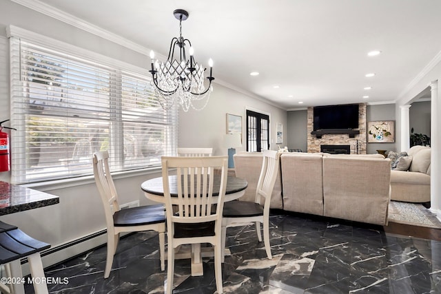 dining room with ornamental molding, a large fireplace, ornate columns, and baseboard heating