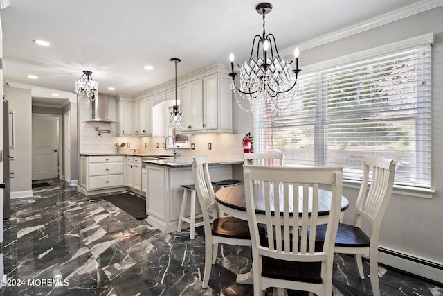 dining room featuring a baseboard radiator, ornamental molding, sink, and a notable chandelier