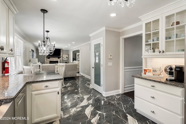 kitchen with ornamental molding, pendant lighting, white cabinets, and dark stone counters