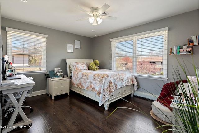 bedroom with ceiling fan, dark hardwood / wood-style floors, and multiple windows