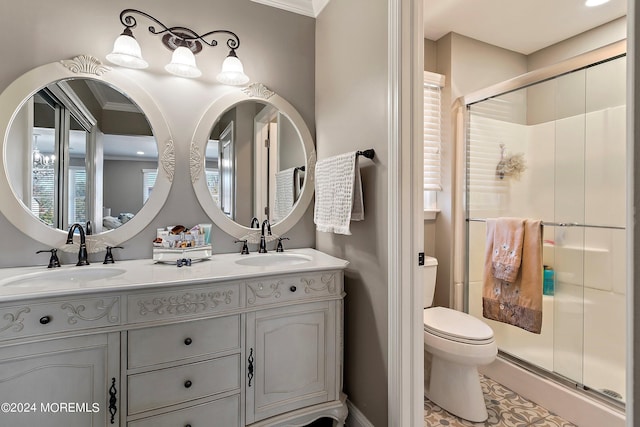 bathroom featuring vanity, toilet, and a shower with shower door