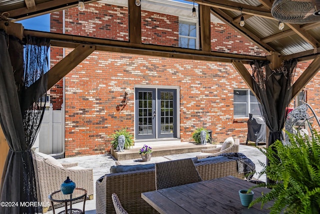 wooden terrace with french doors and a patio