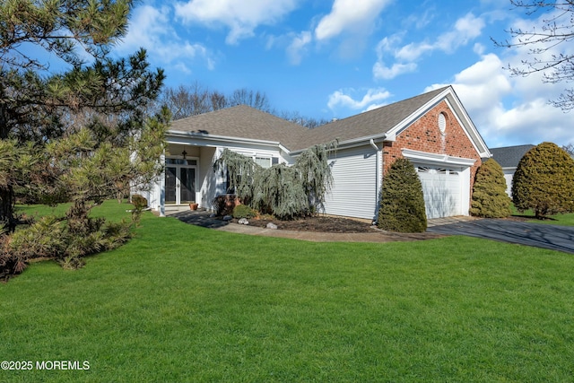 view of front of property with a front yard and a garage