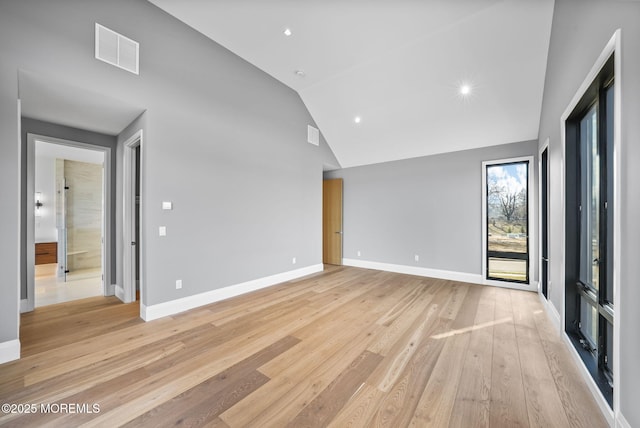 unfurnished living room featuring high vaulted ceiling and light hardwood / wood-style floors