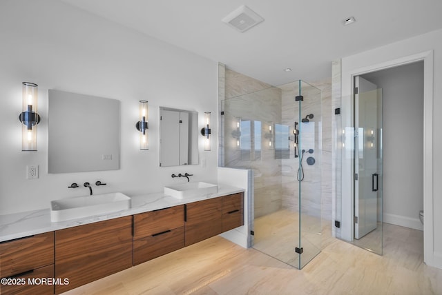 bathroom featuring vanity and a shower with door