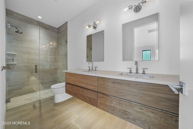 bathroom featuring vanity, toilet, and walk in shower