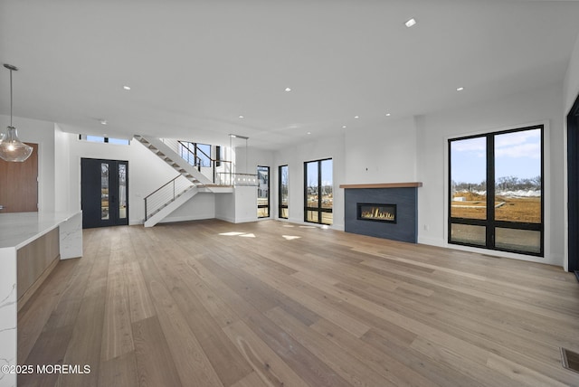 unfurnished living room with light hardwood / wood-style flooring and french doors