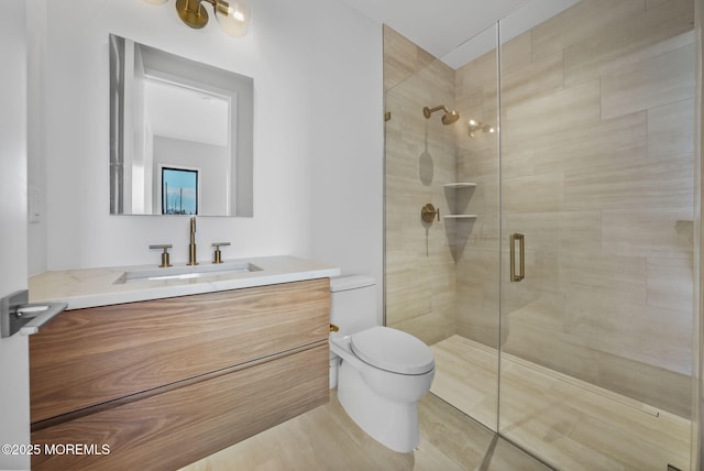 bathroom featuring walk in shower, vanity, and toilet