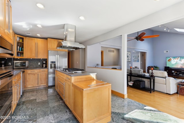 kitchen featuring stainless steel appliances, dark countertops, backsplash, glass insert cabinets, and vaulted ceiling