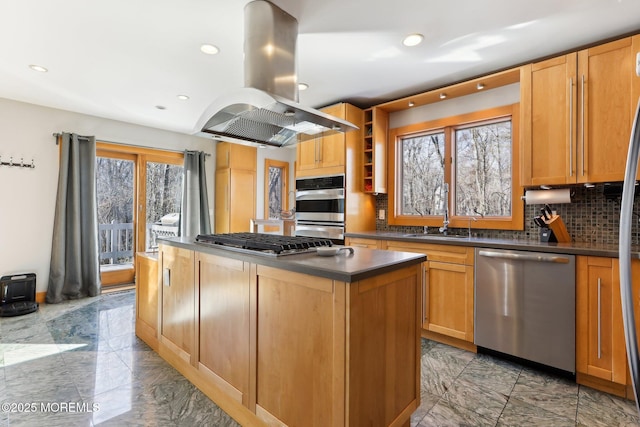 kitchen featuring marble finish floor, island exhaust hood, dark countertops, appliances with stainless steel finishes, and a kitchen island