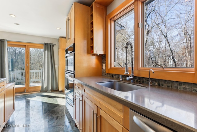 kitchen featuring decorative backsplash, marble finish floor, stainless steel dishwasher, a sink, and recessed lighting