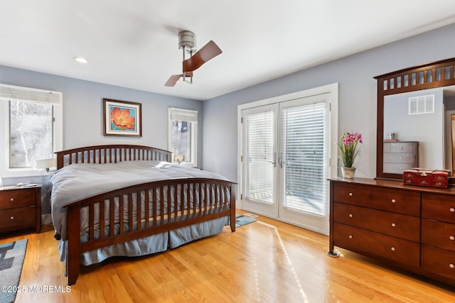 bedroom featuring visible vents, a ceiling fan, wood finished floors, access to exterior, and french doors