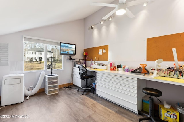 home office with ceiling fan, vaulted ceiling, and wood finished floors