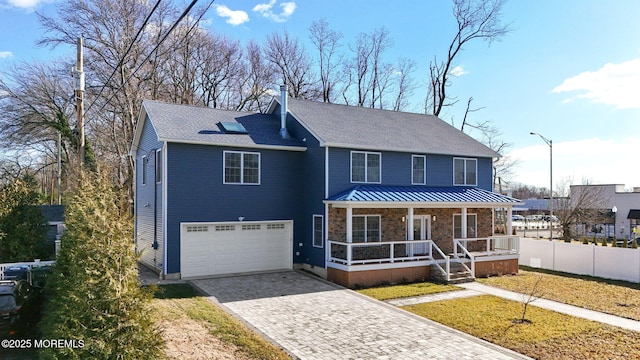 view of front facade with a garage and a porch