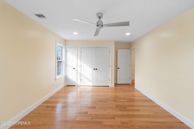 unfurnished bedroom featuring light hardwood / wood-style floors, a closet, and ceiling fan