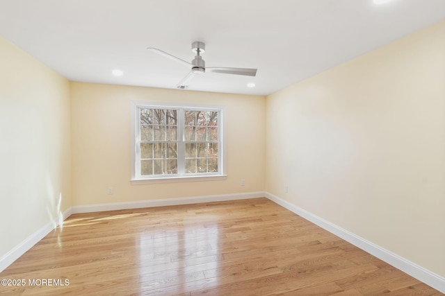 spare room featuring ceiling fan and light wood-type flooring