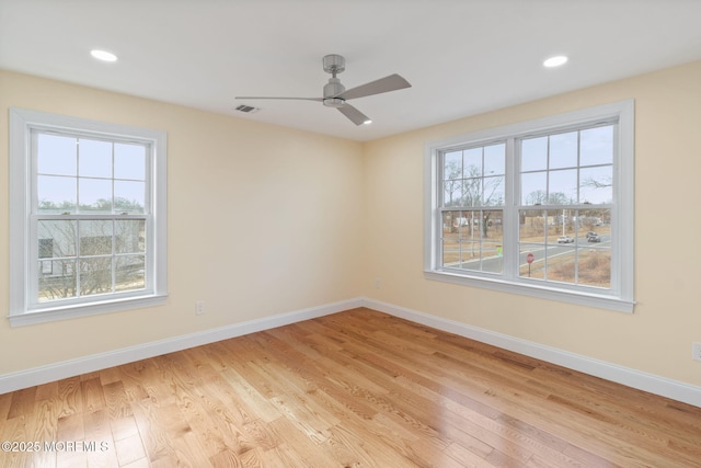 empty room featuring ceiling fan and light hardwood / wood-style floors