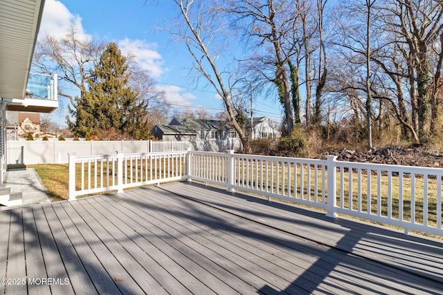 wooden terrace featuring a yard