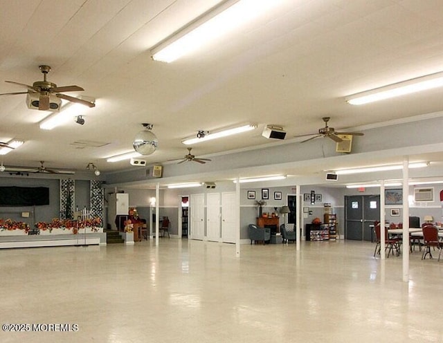 garage with ceiling fan and an AC wall unit