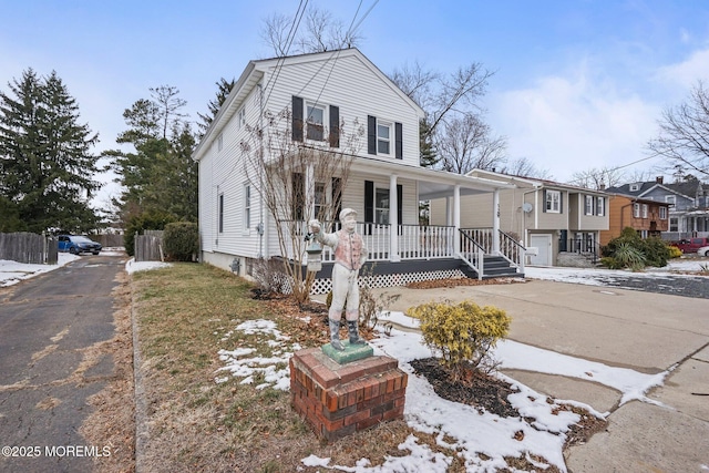 view of front of property featuring a garage and covered porch