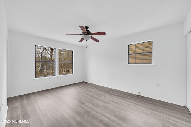 unfurnished room featuring hardwood / wood-style flooring, a textured ceiling, and ceiling fan