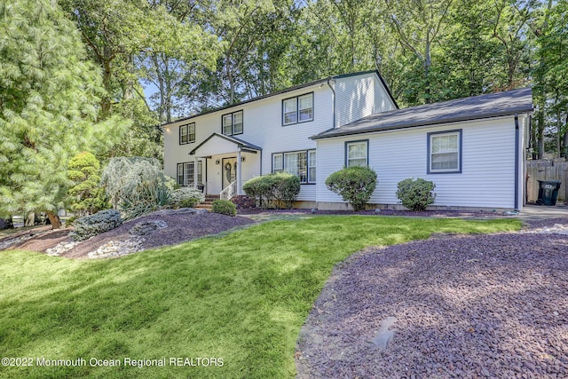 colonial-style house with a front yard