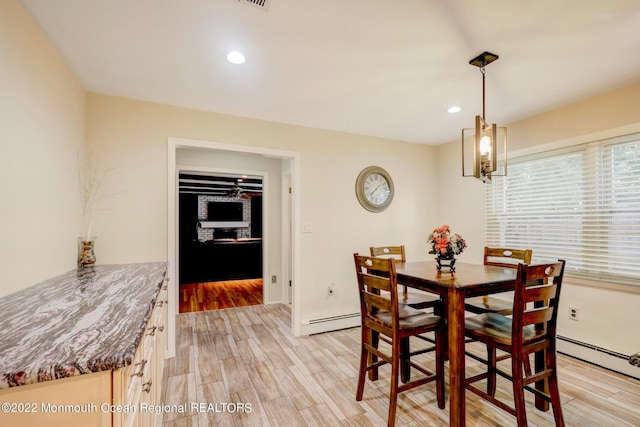 dining space featuring recessed lighting, baseboards, light wood-style floors, and a baseboard radiator