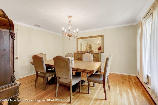 dining space featuring a notable chandelier, visible vents, light wood finished floors, and ornamental molding