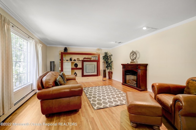 living room with a fireplace, crown molding, light wood-style floors, and a baseboard radiator