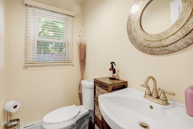 bathroom with toilet and a sink