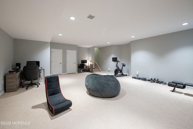 exercise room with light colored carpet