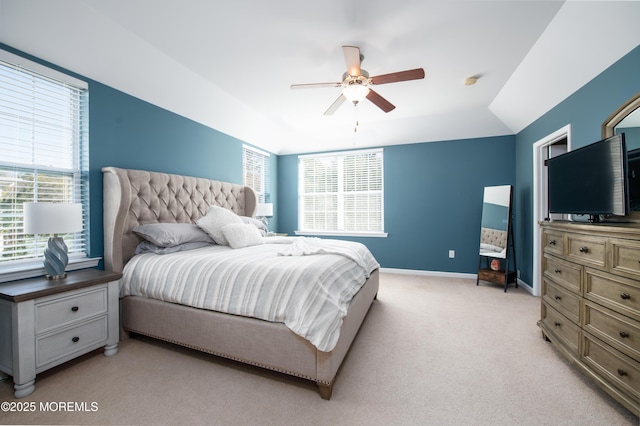 bedroom featuring vaulted ceiling, light colored carpet, and ceiling fan