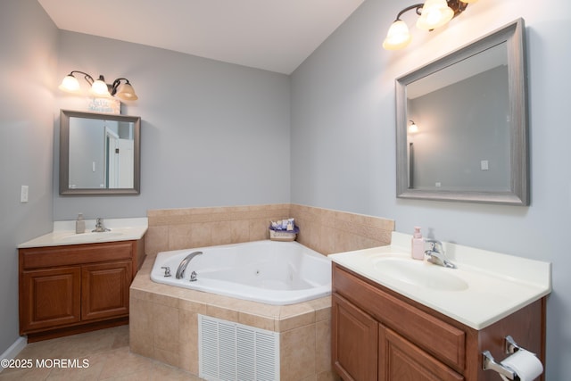 bathroom featuring vanity, tiled tub, and tile patterned flooring