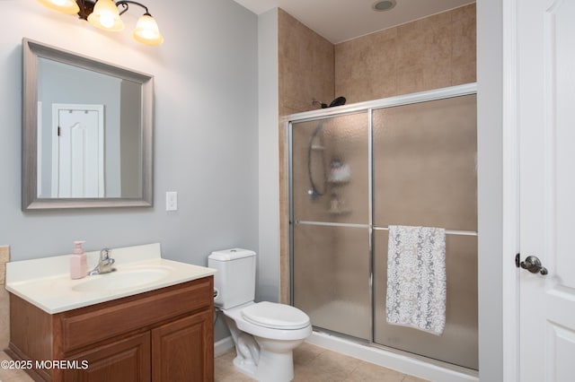 bathroom featuring vanity, tile patterned floors, a shower with door, and toilet