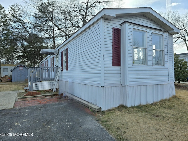 view of side of property featuring a storage shed