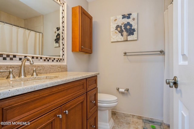 bathroom with vanity, tile patterned flooring, and toilet