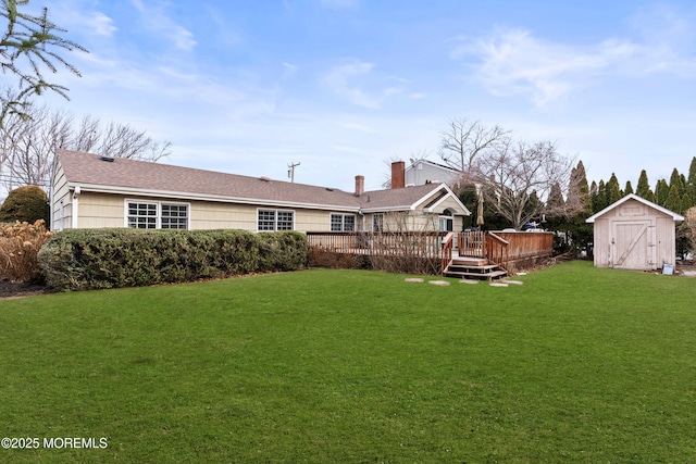 view of yard featuring an outdoor structure, a deck, and a storage unit