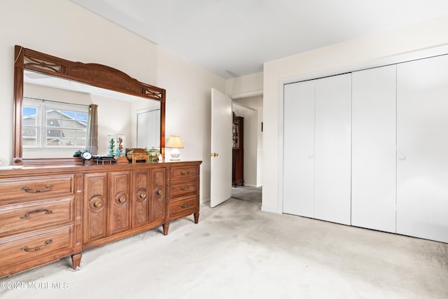 bedroom featuring a closet and light colored carpet