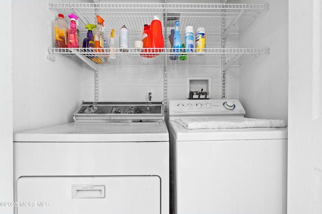 clothes washing area featuring laundry area and washing machine and dryer