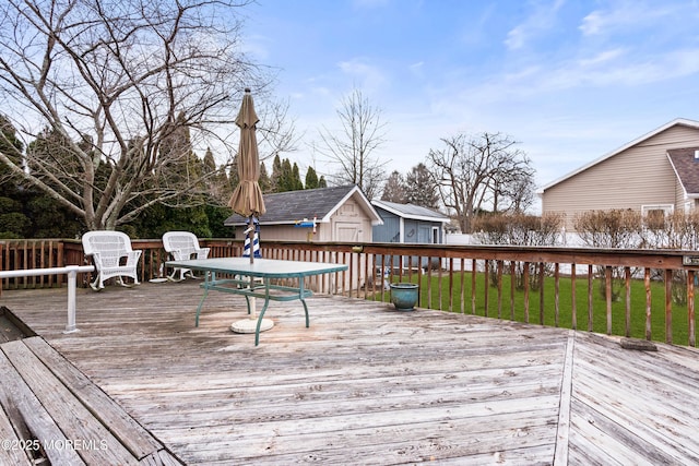 deck with an outbuilding and a lawn