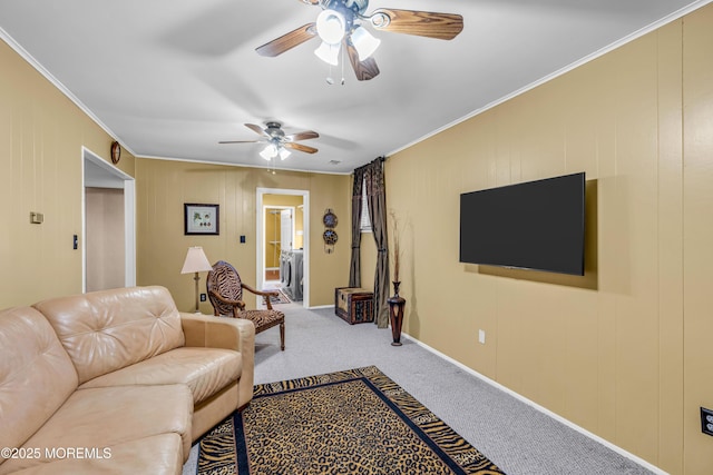 living room with crown molding, carpet floors, washer / dryer, and ceiling fan