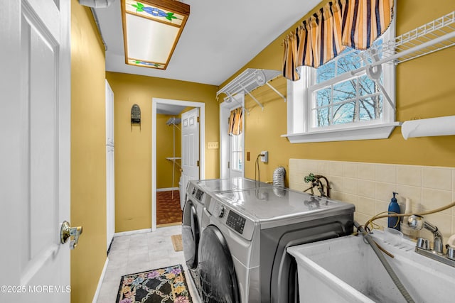 laundry area with sink and washing machine and dryer