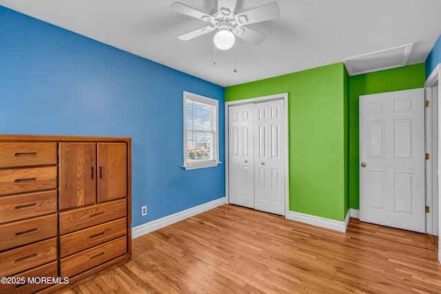 unfurnished bedroom with a closet, ceiling fan, and light wood-type flooring