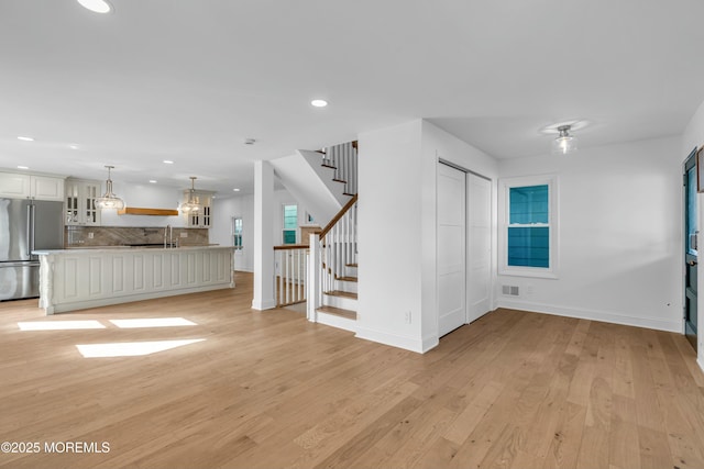 unfurnished living room featuring light hardwood / wood-style flooring