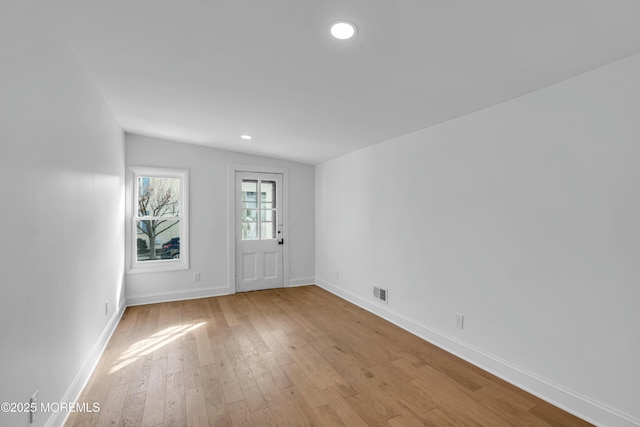 spare room featuring light wood-type flooring