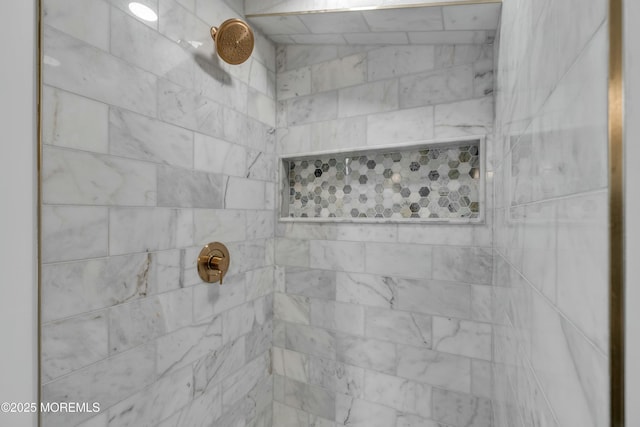 interior details featuring a tile shower