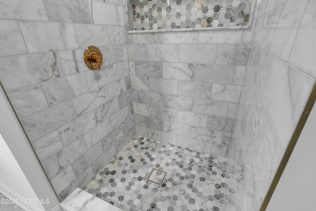 bathroom with tiled shower