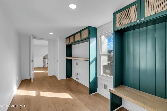 mudroom with light hardwood / wood-style floors