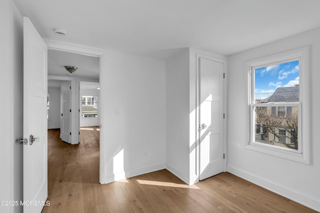 unfurnished room featuring a healthy amount of sunlight and light wood-type flooring