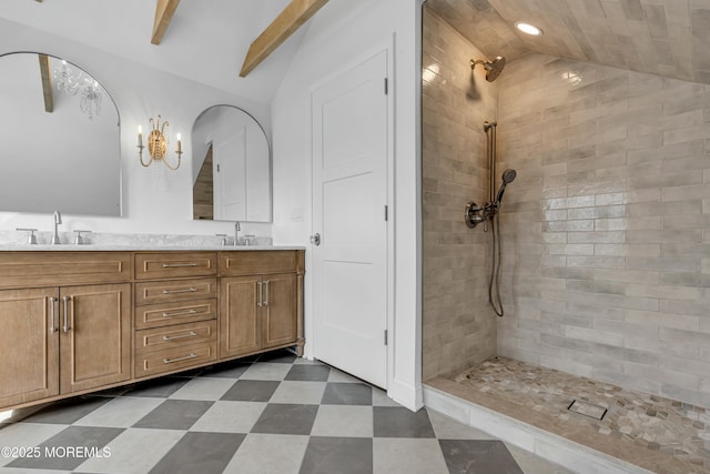 bathroom with vanity, vaulted ceiling with beams, and a tile shower